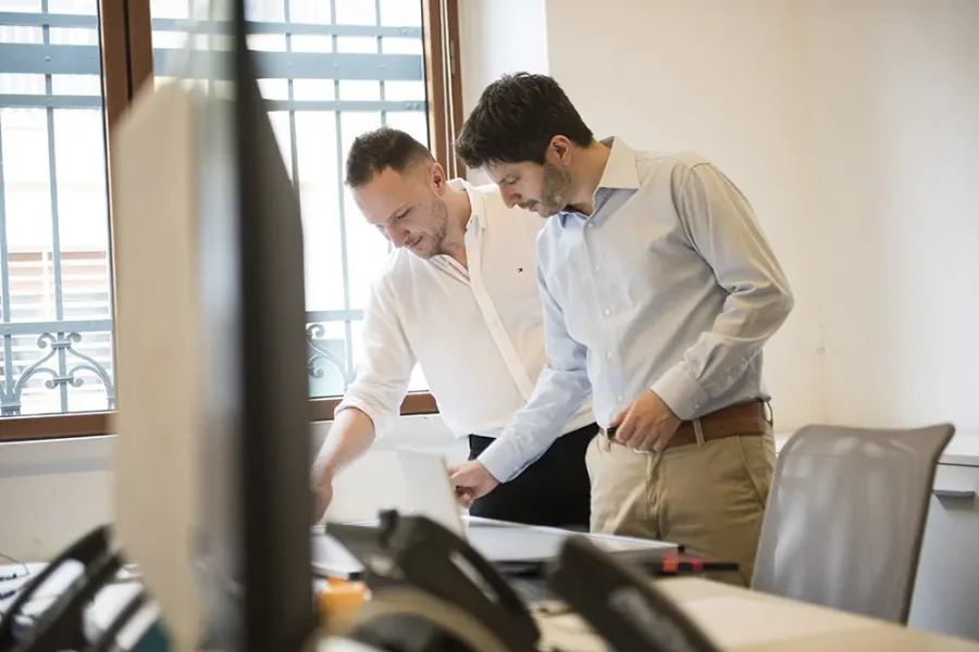 Two Fiabilis consultants reviewing a document together at a desk